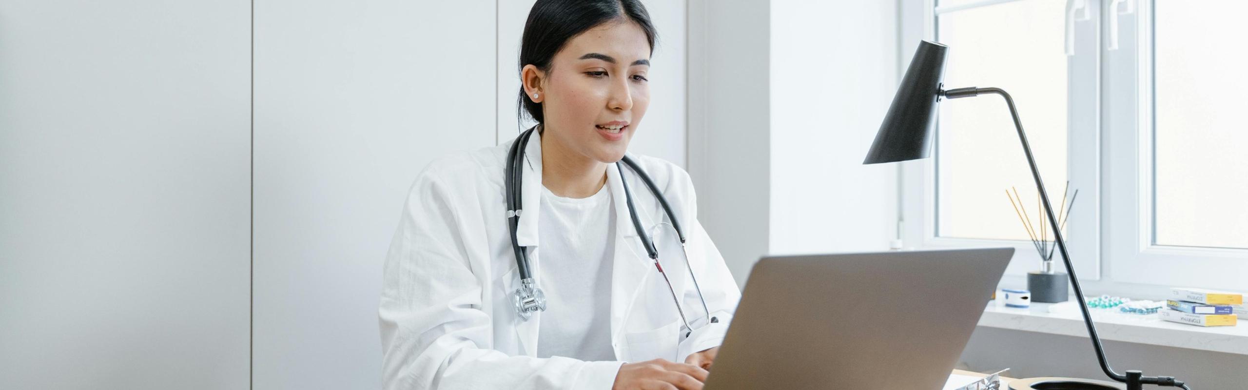woman doctor with a laptop speaking