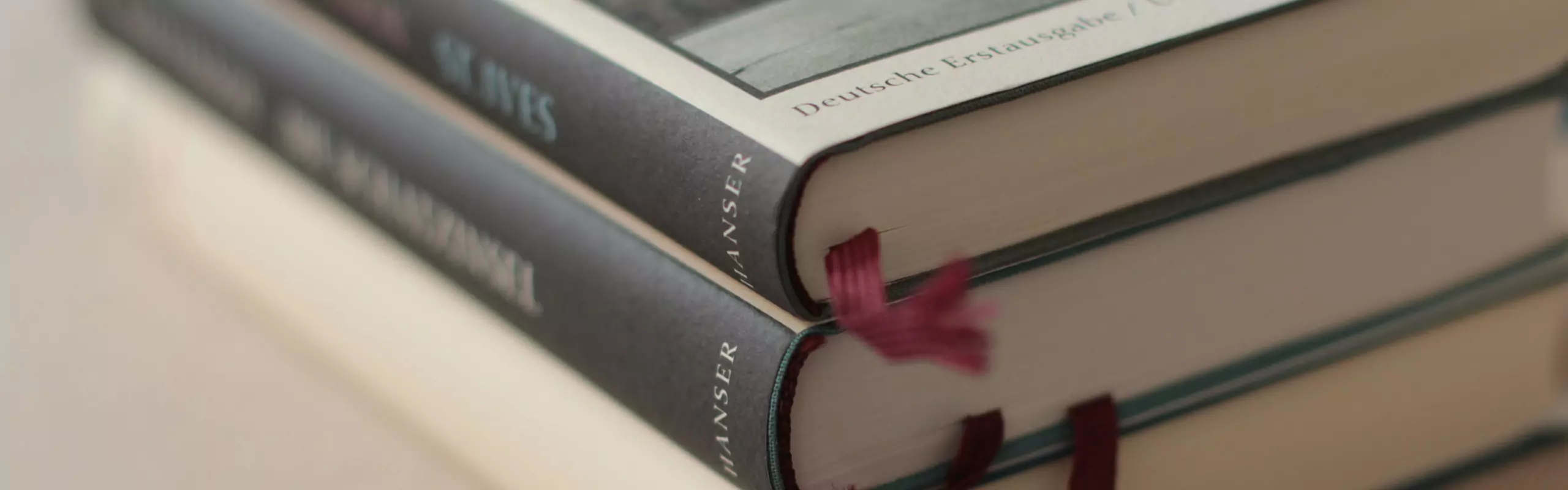 Stack of books with bookmarks on a table